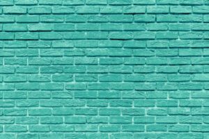 The background of the old green brick wall for design interior and  various scenes or as a background for video interviews.